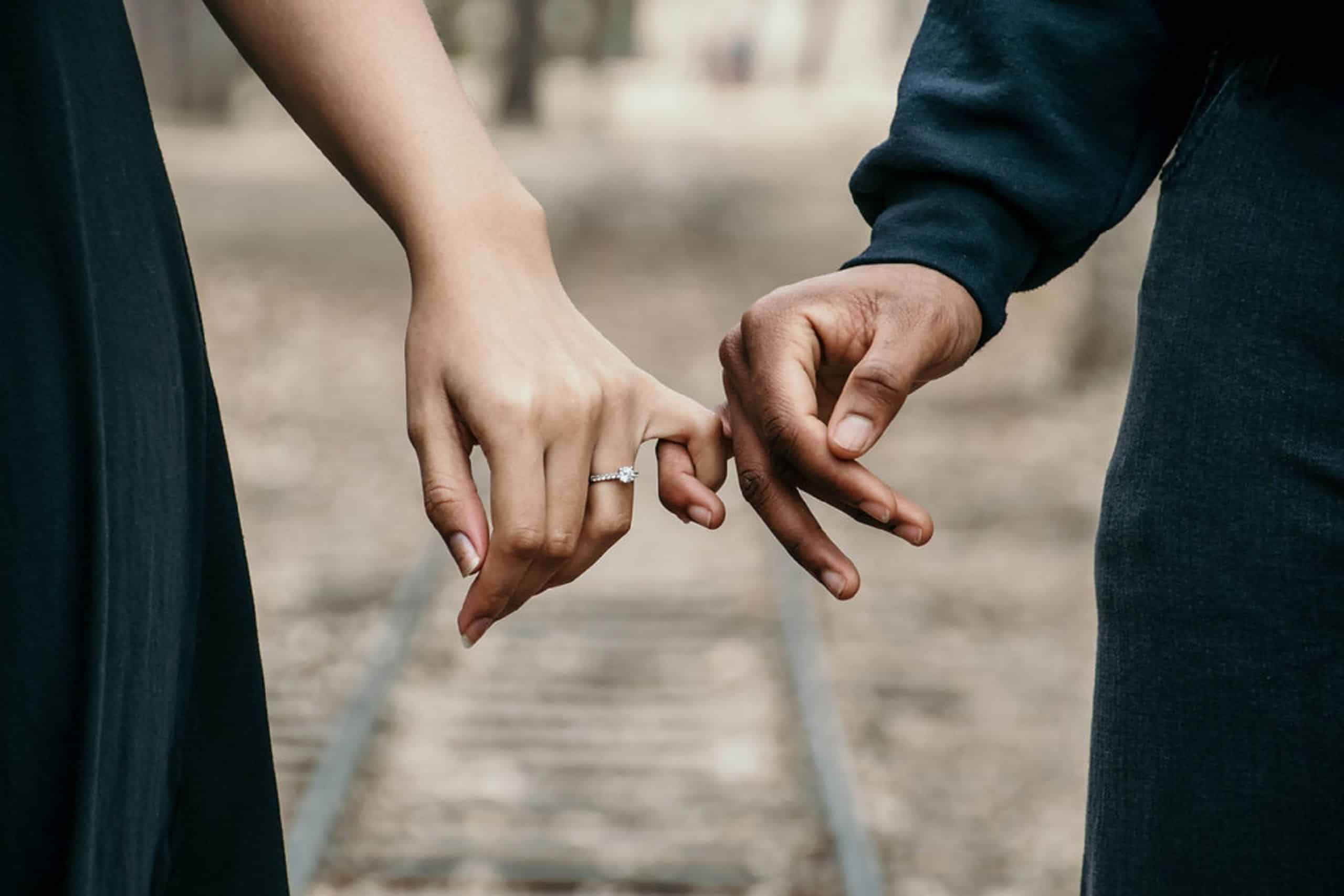 a man and a woman hold hands
