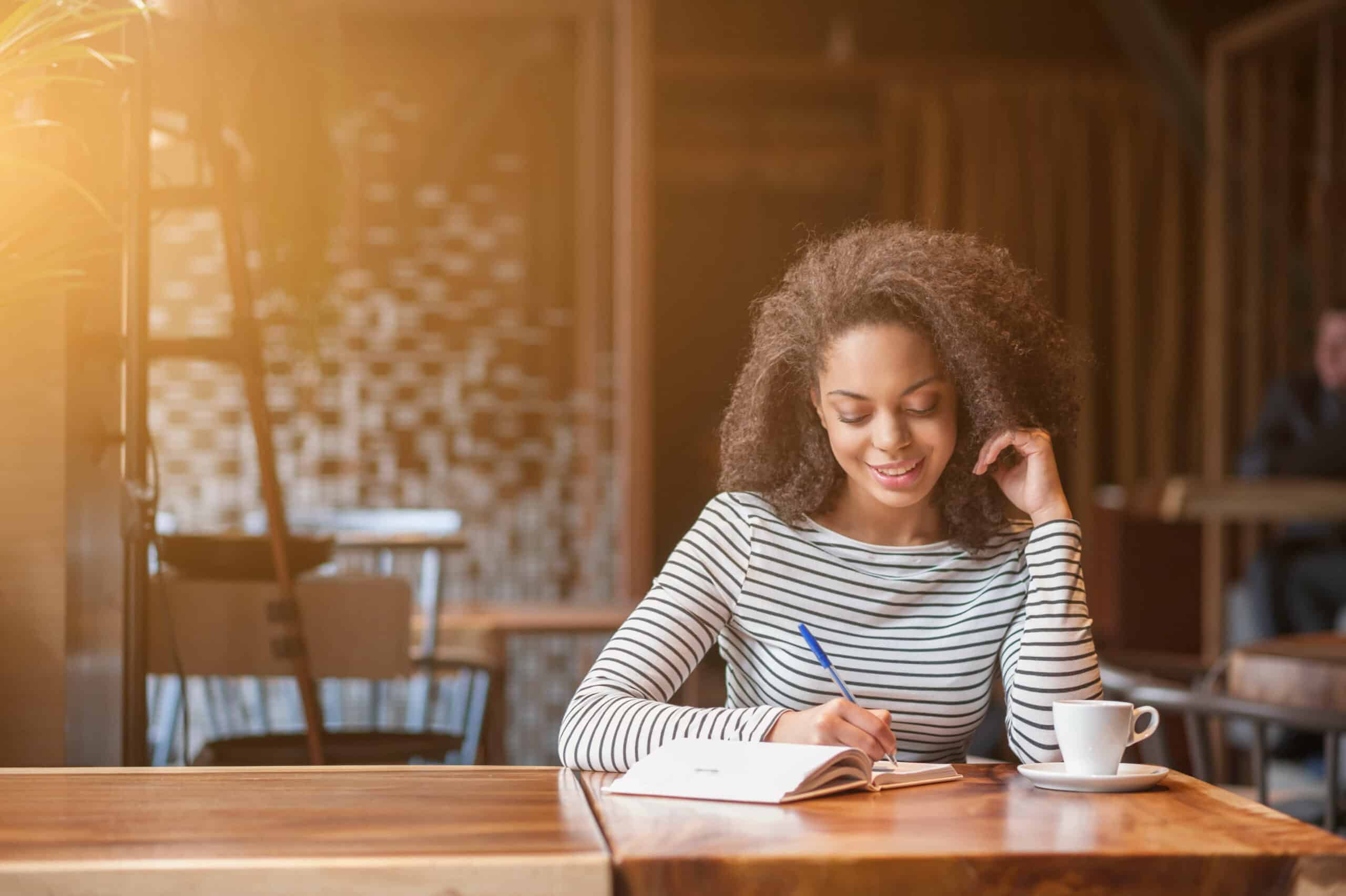 a girl writing at a table